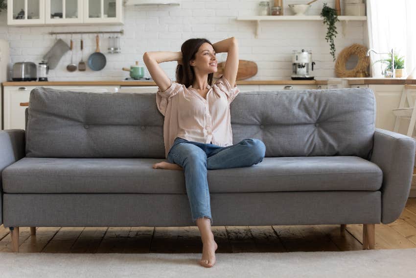 woman sitting on couch smiling