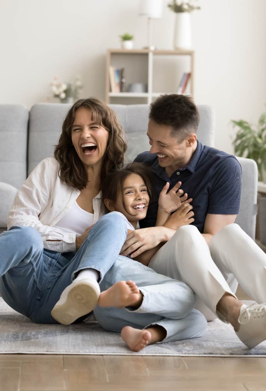 Parents and kid being playful and laughing together