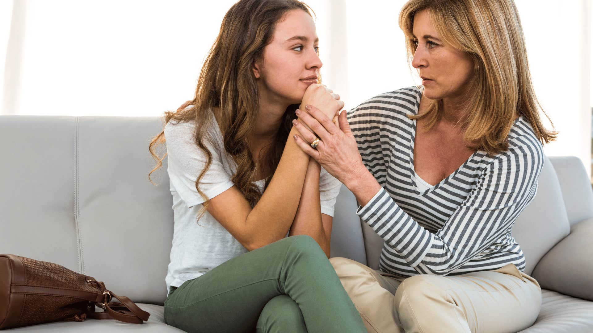 mother comforting teenage daughter