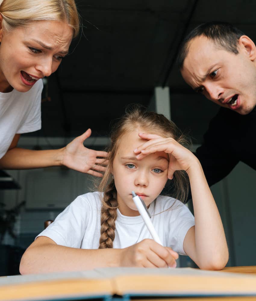 parents disciplining misbehaved child