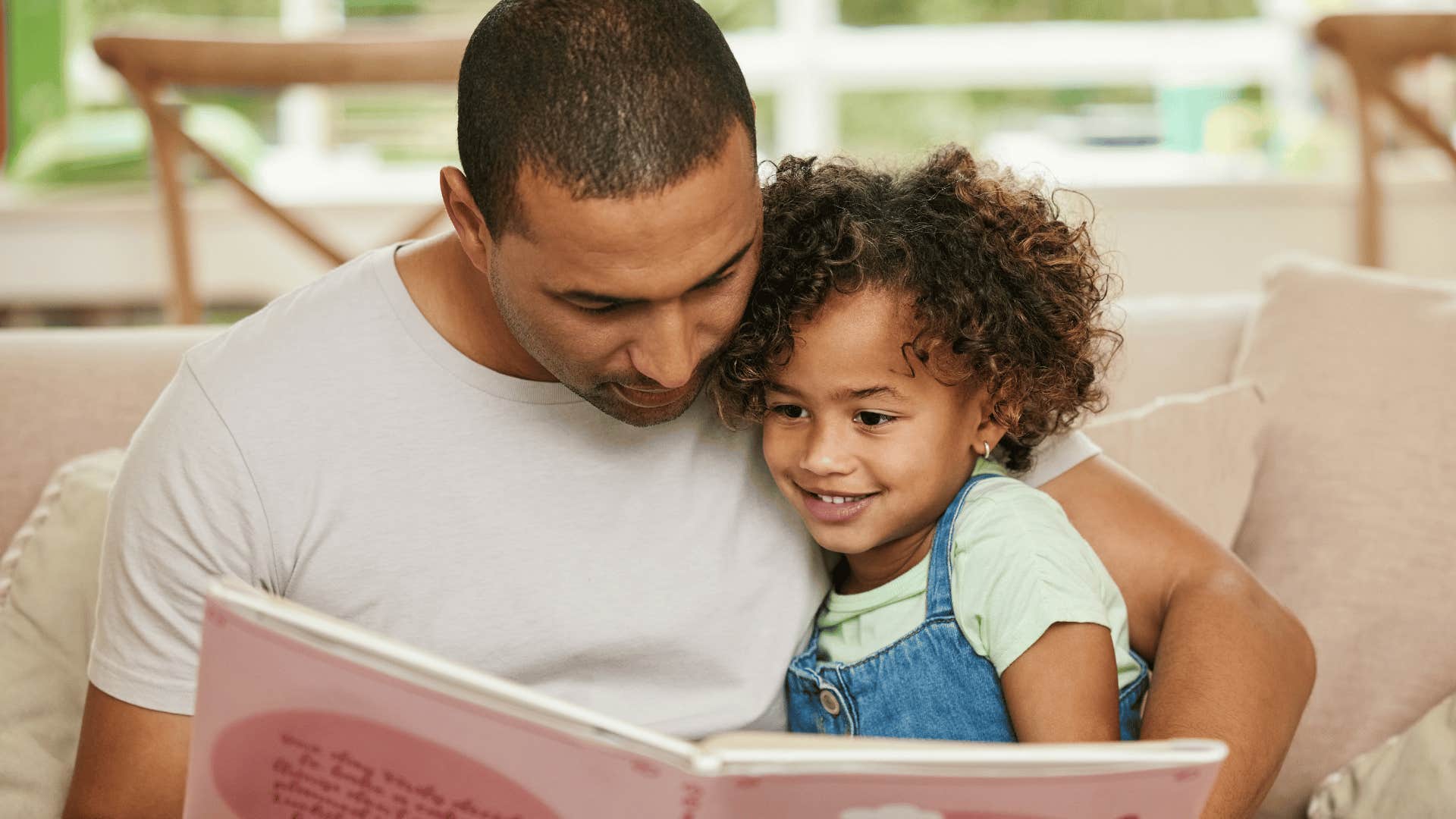 man reading book to child