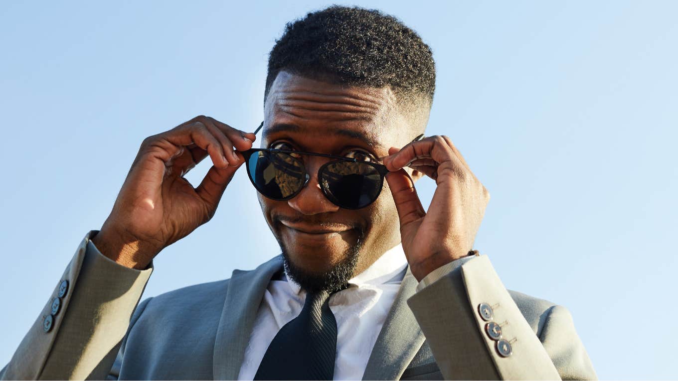 Handsome Black man on the rebound, looking over his glasses