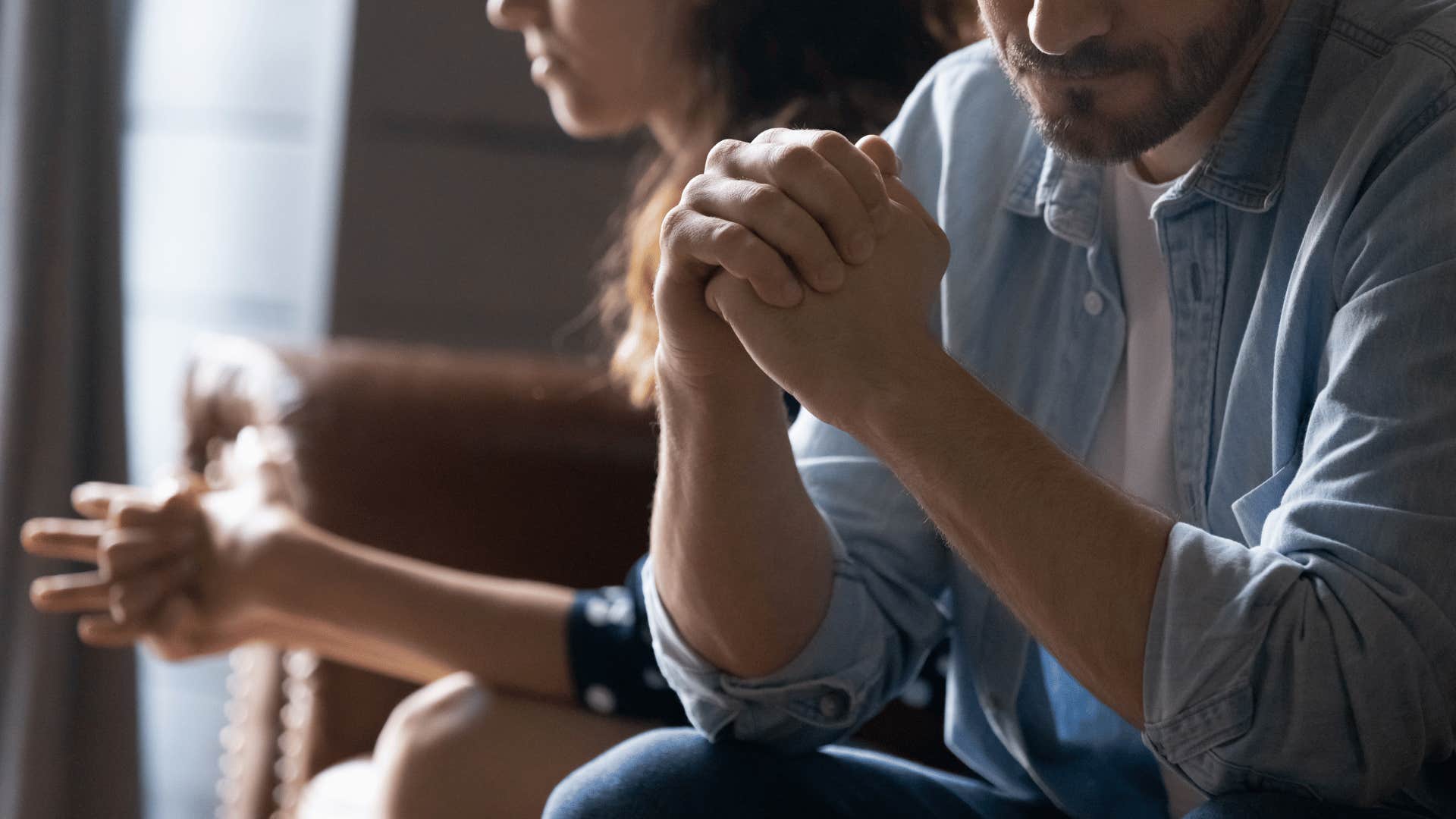 couple sitting next to each other not talking