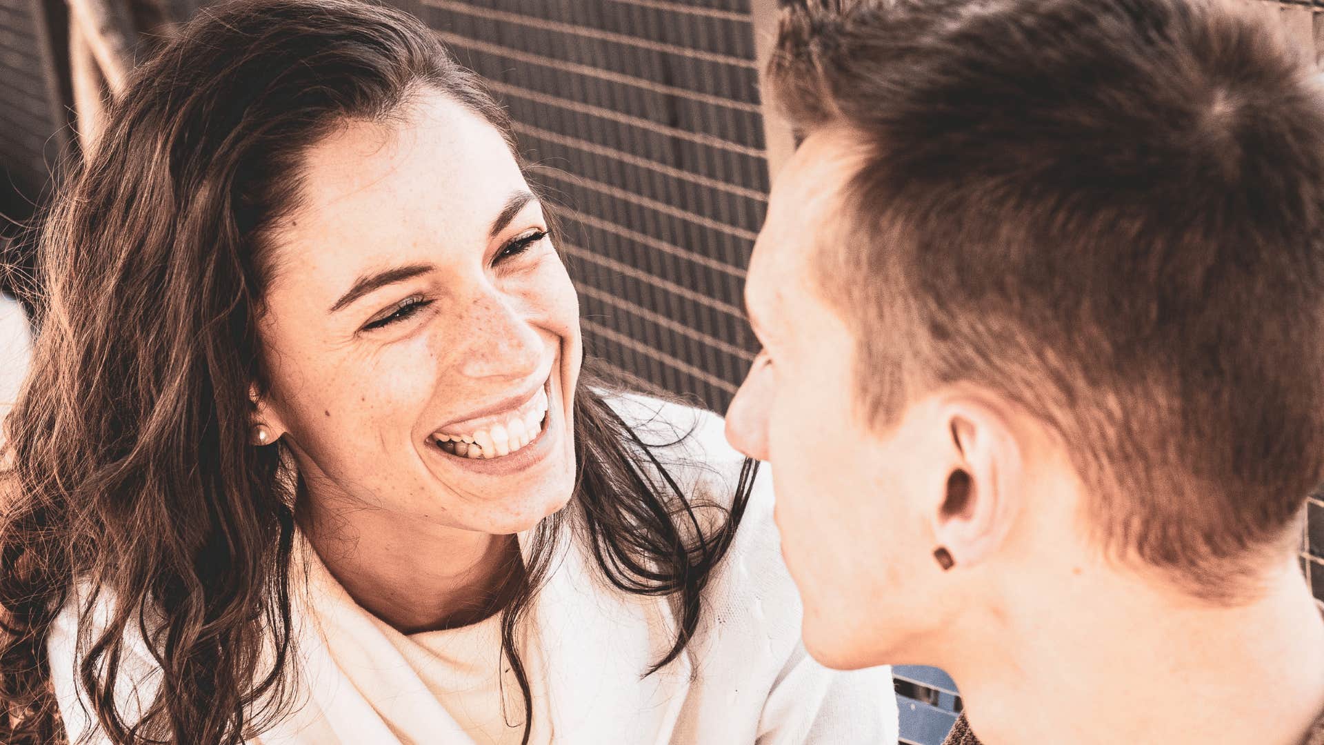 woman laughing next to man