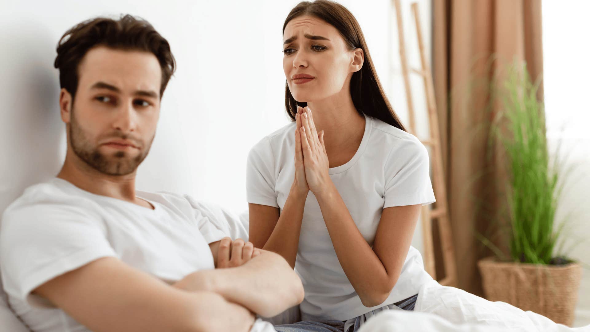 woman pleading with man ignoring her