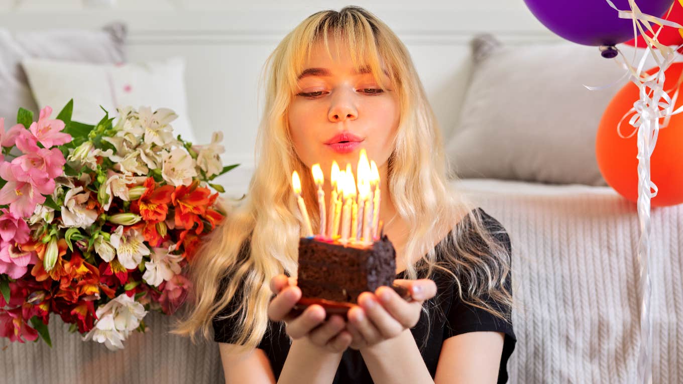 Woman destined for financial success holding birthday cake