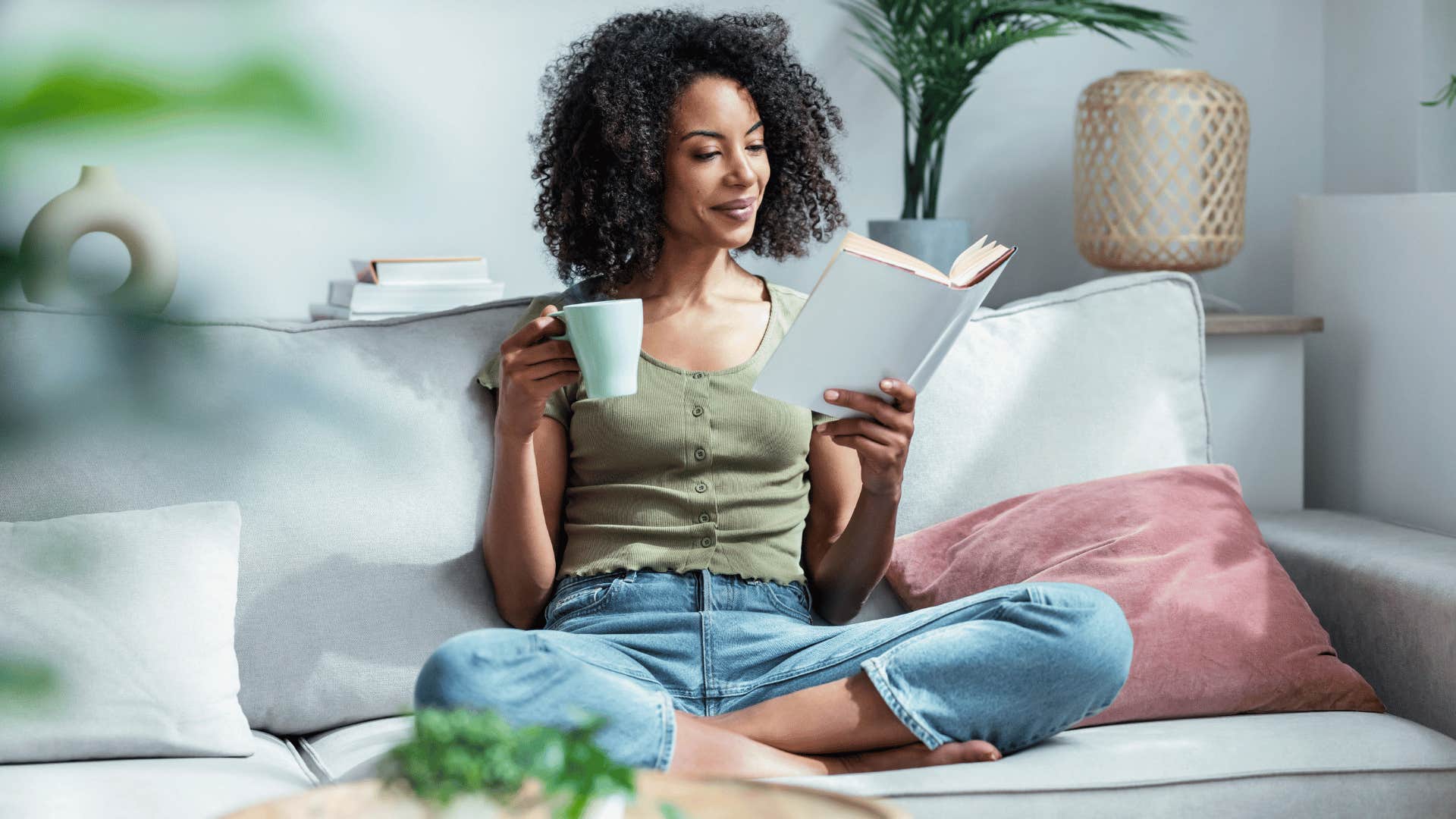 woman reading book and drinking tea