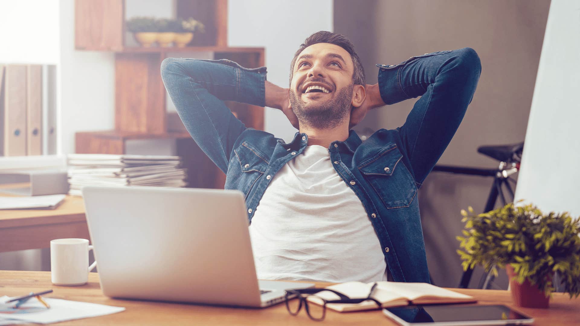 man relaxing while on laptop