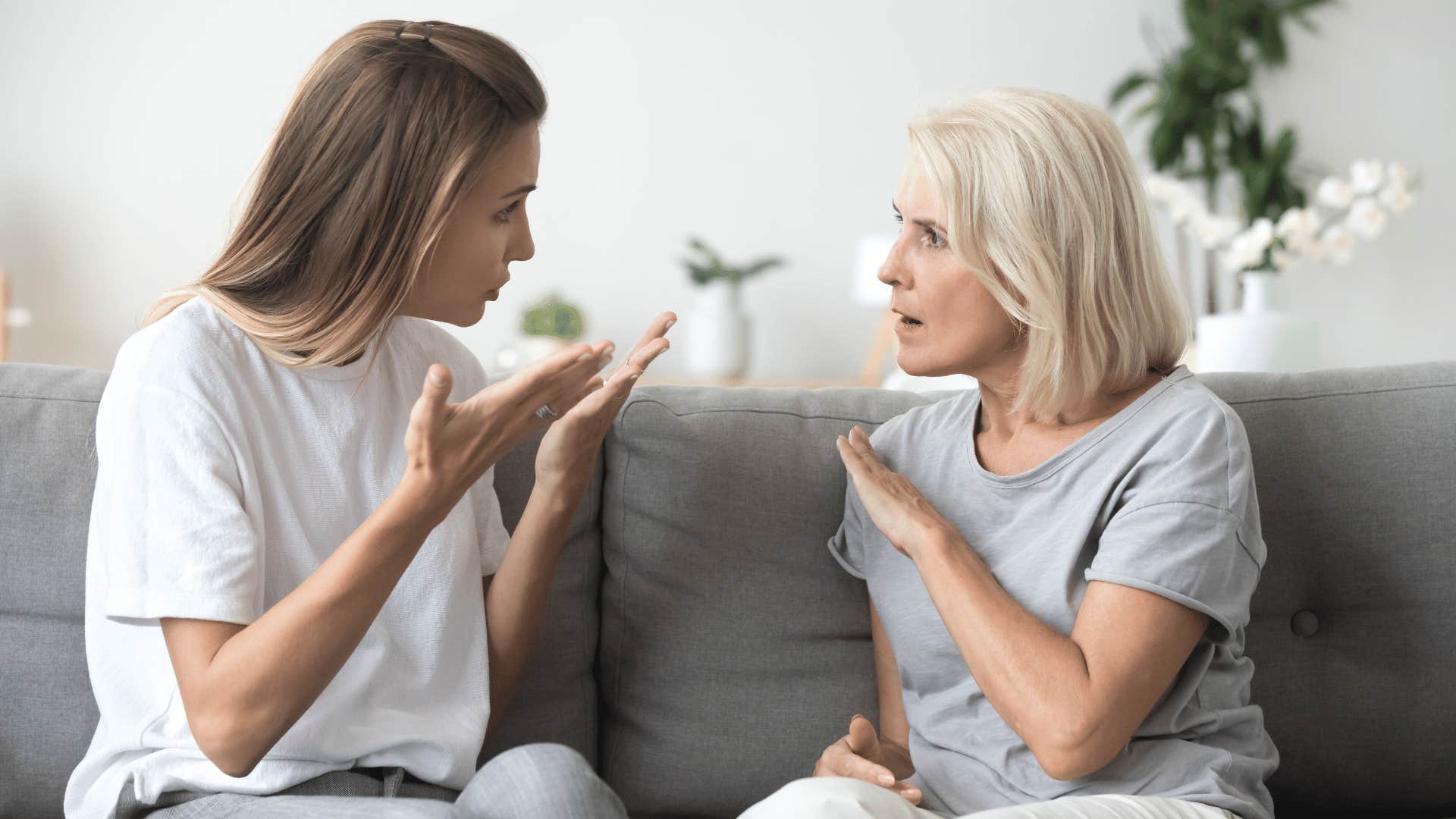 older woman arguing with younfer woman on couch