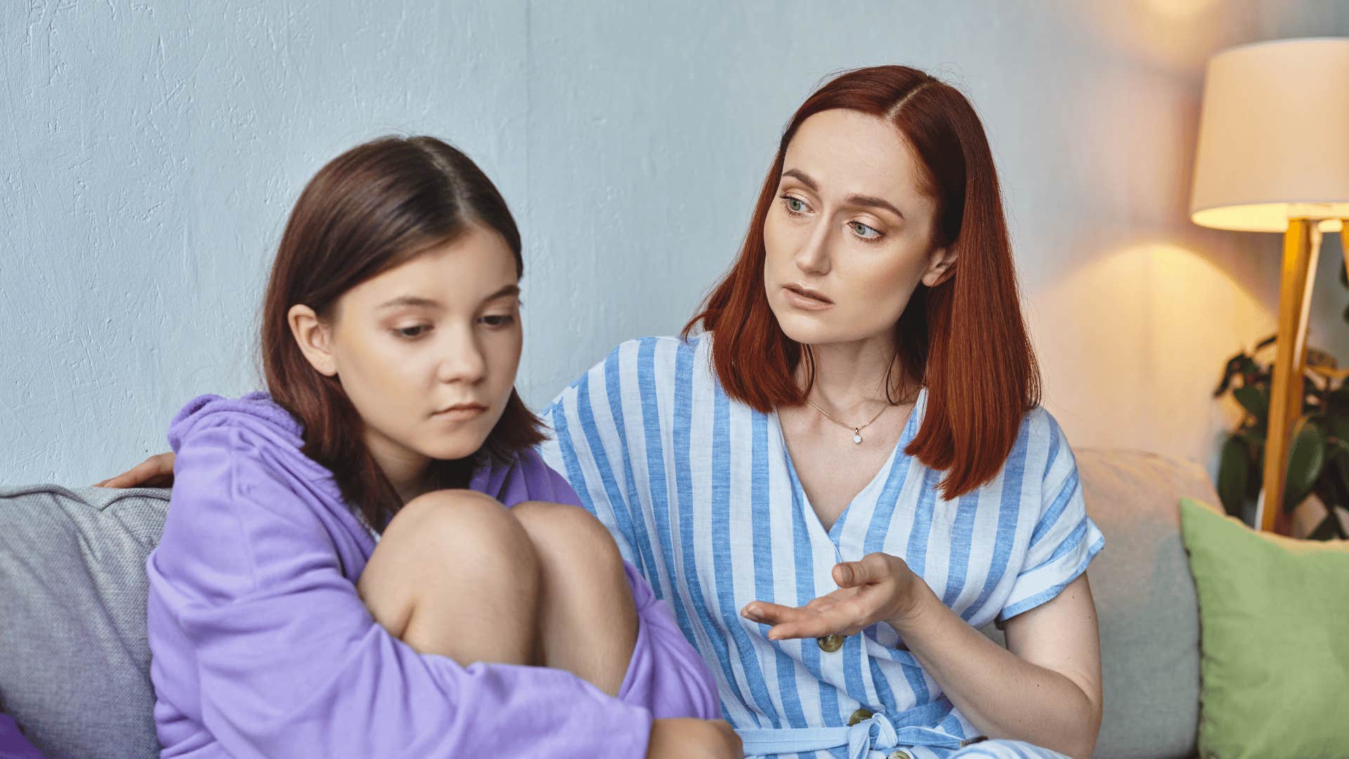 upset daughter sitting next to mother