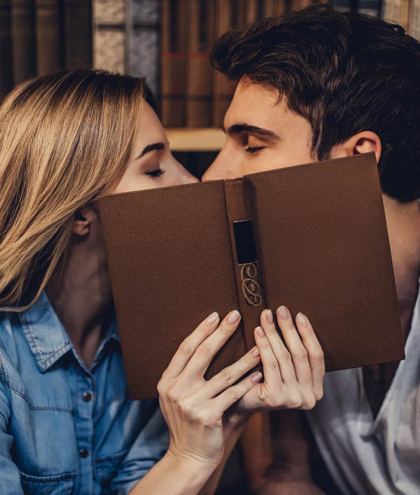 couple kissing in school library