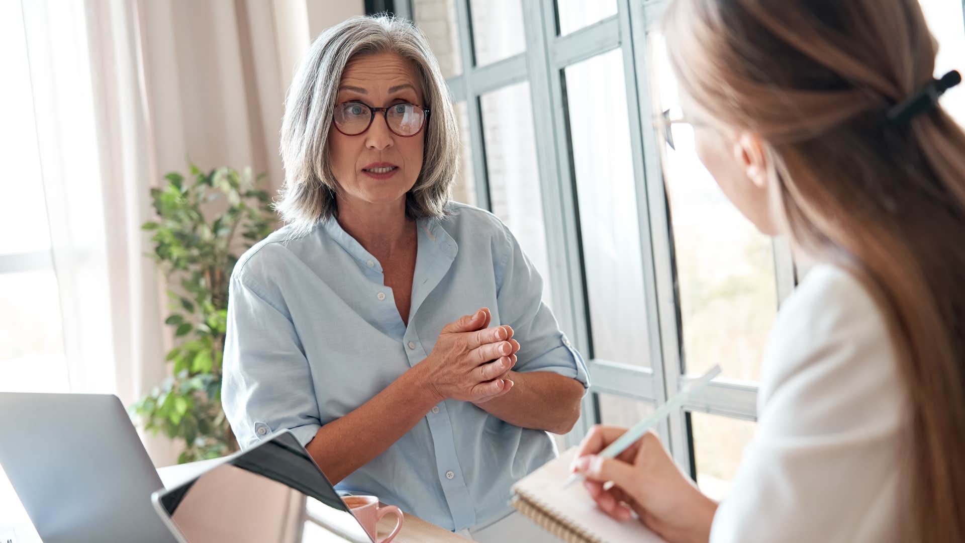 Woman having a serious conversation with a younger peer.