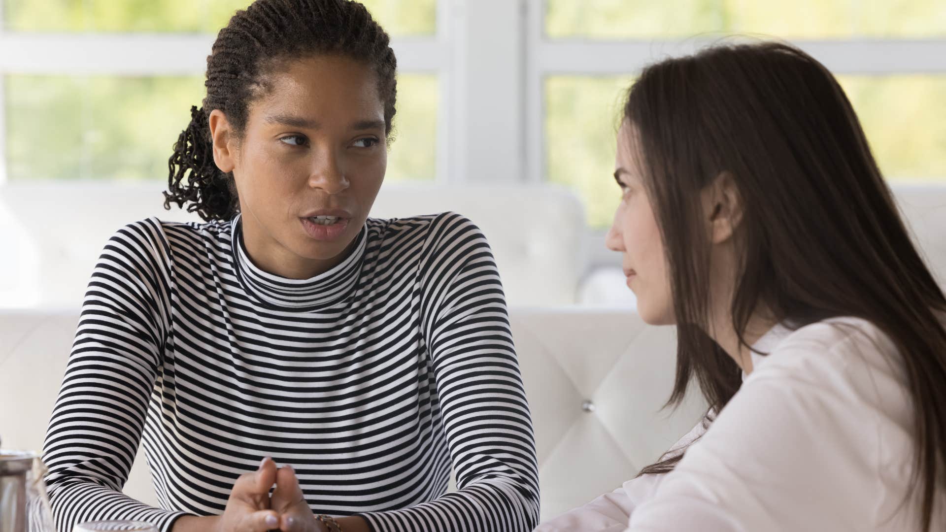 Two women having a serious conversation.