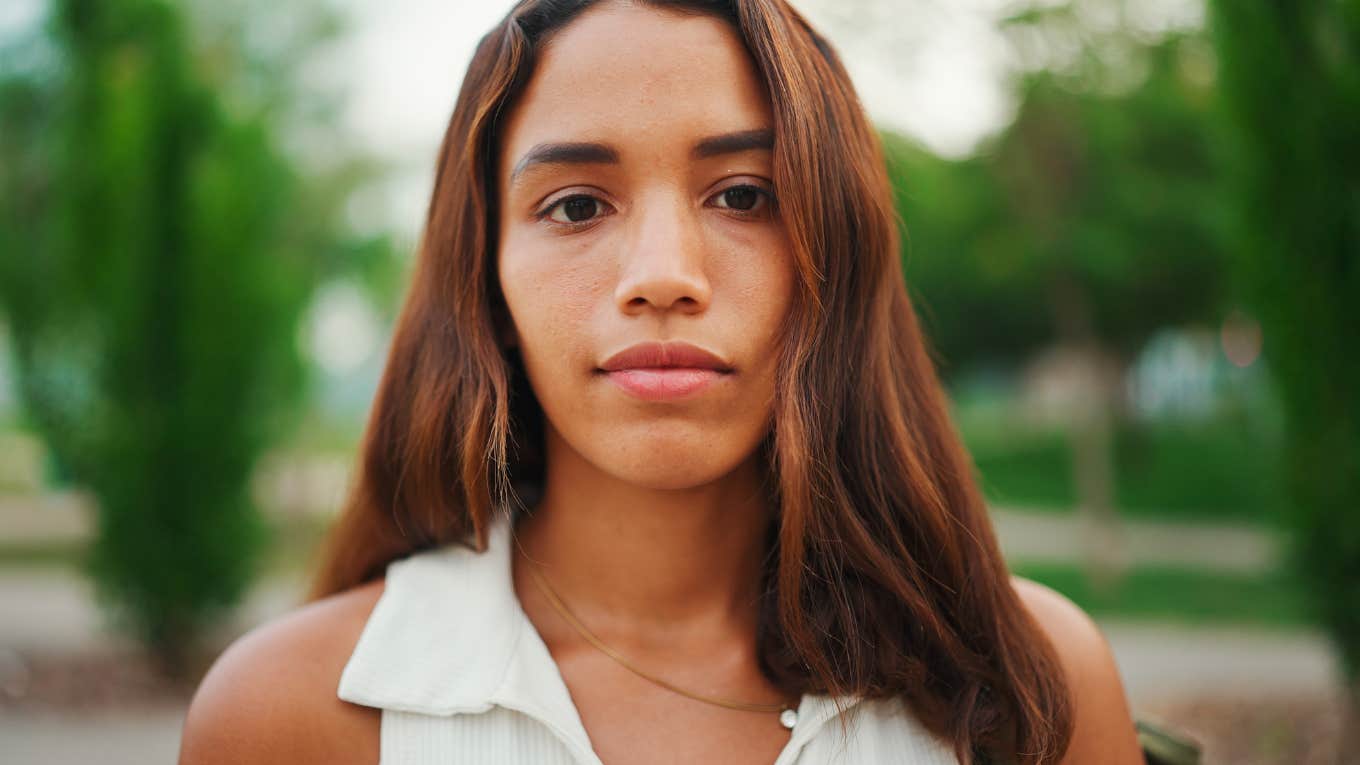 Serious young woman staring directly at the camera.