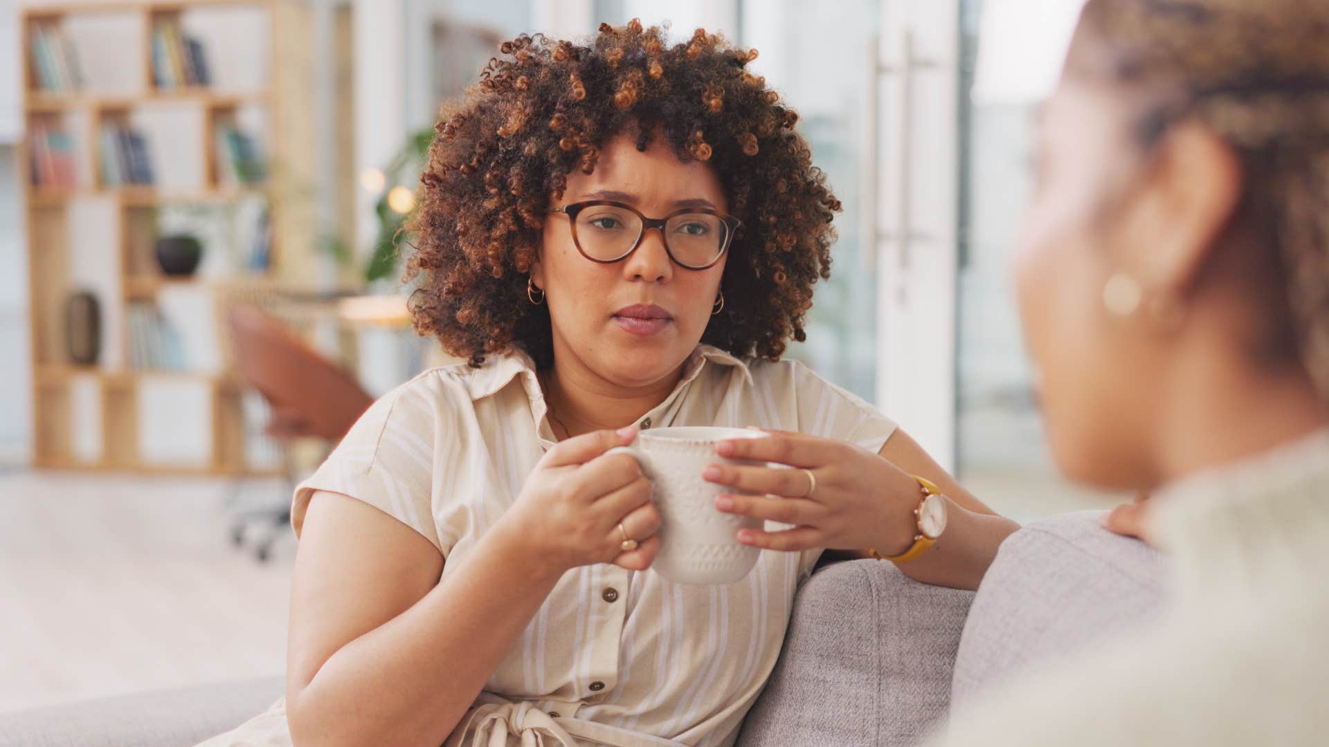 Woman looking annoyed talking to her friend.