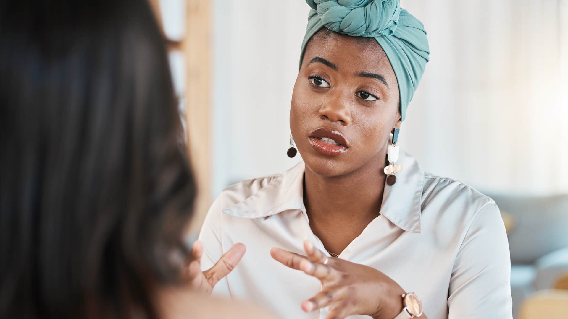 Woman having a serious conversation with a co-worker.