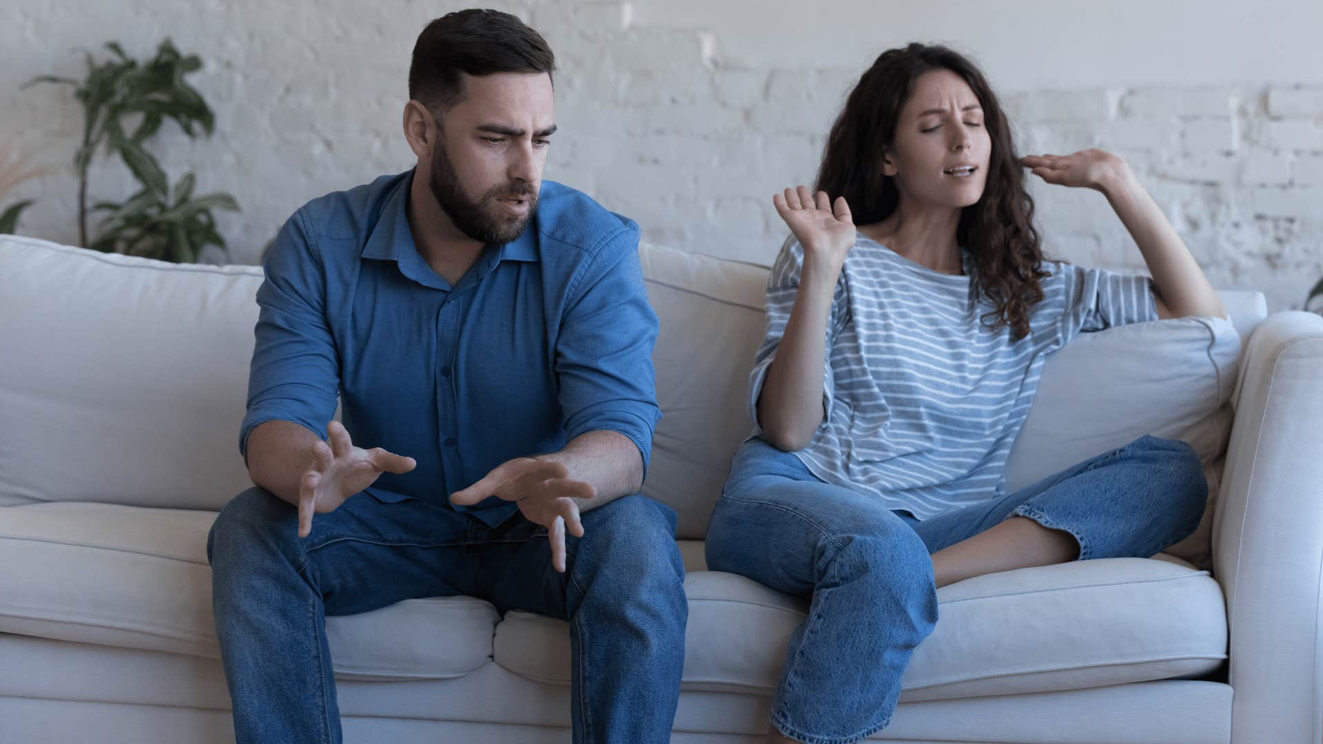 woman getting defensive against man