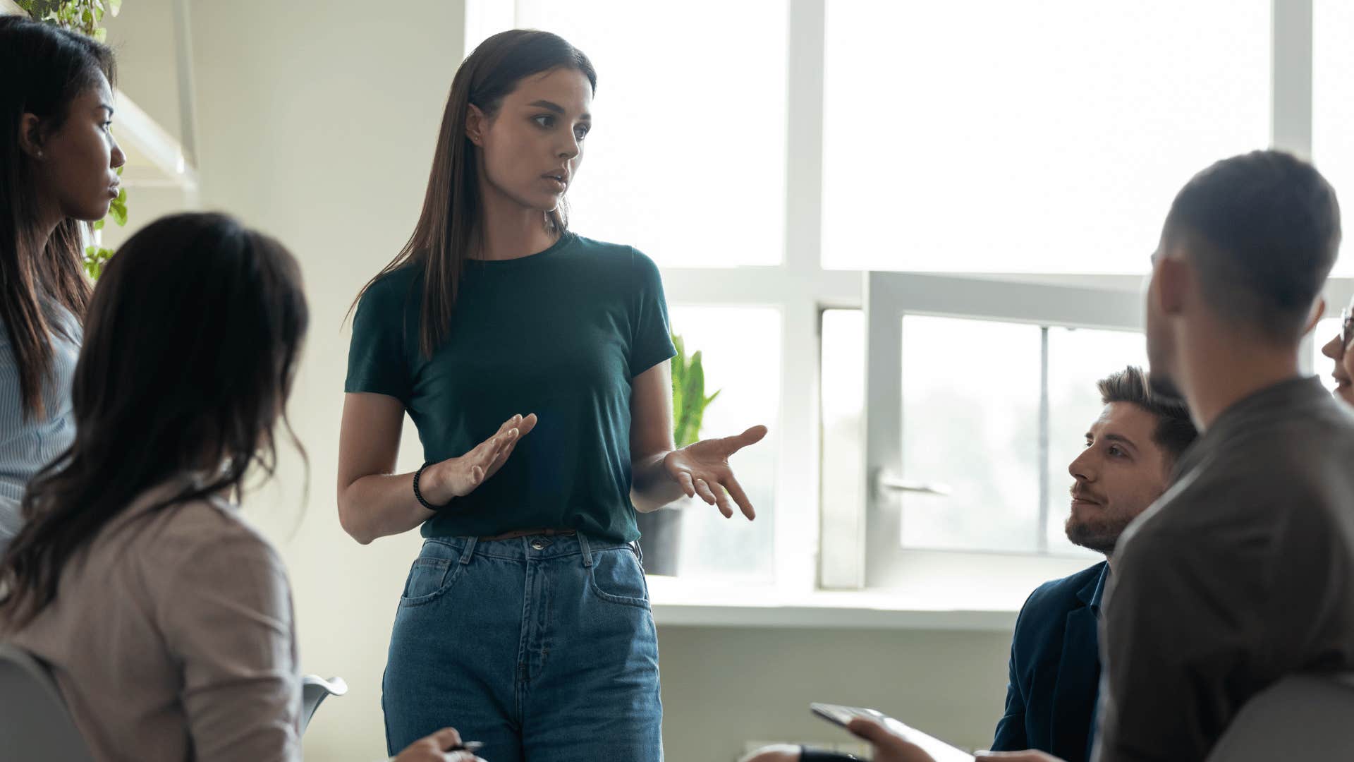 woman explaining information to co-workers