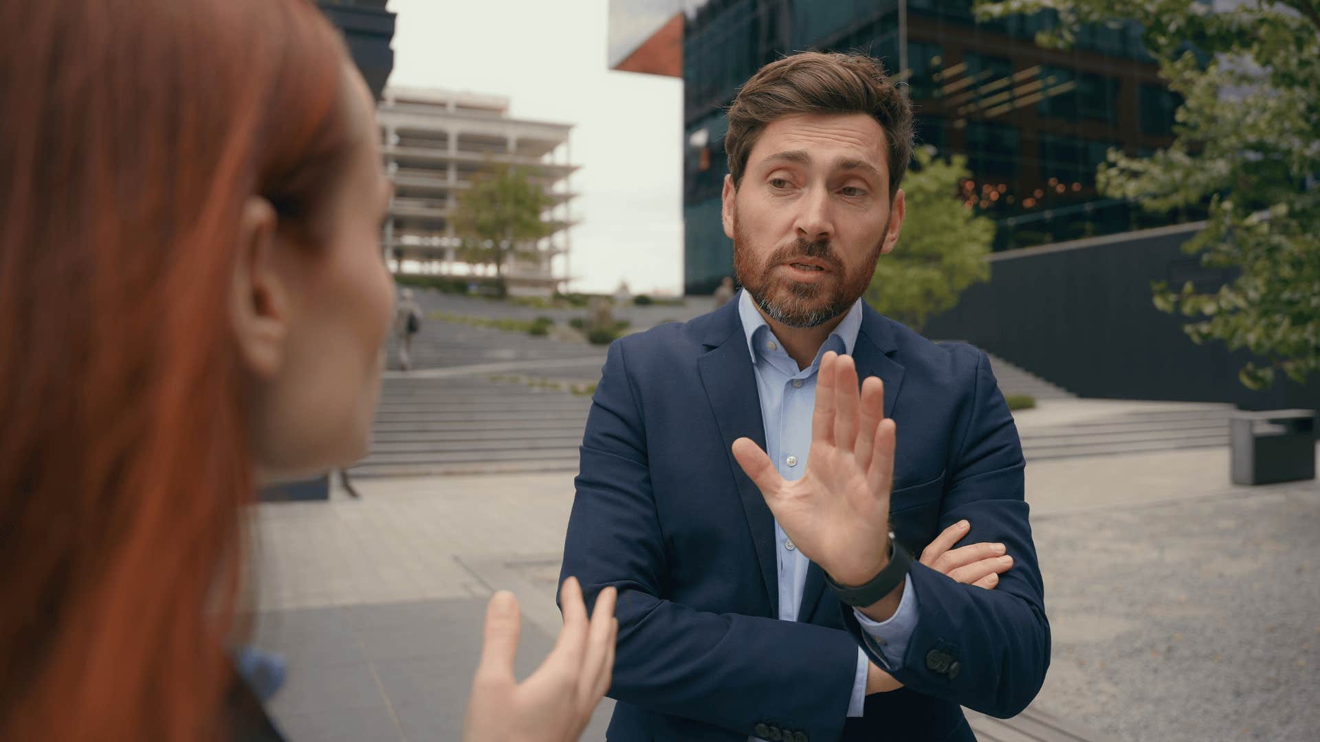 businessman telling woman it's not his job to help