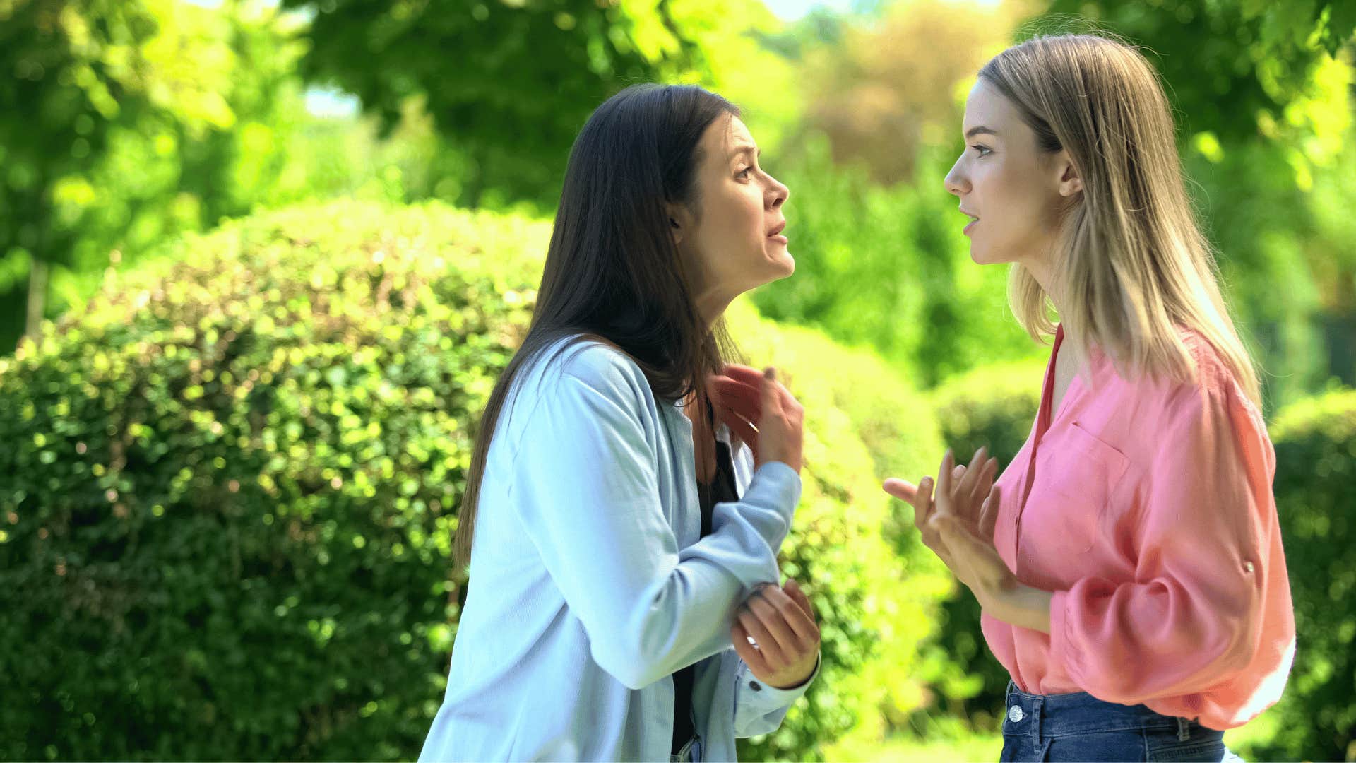 two women arguing while one woman points to herself