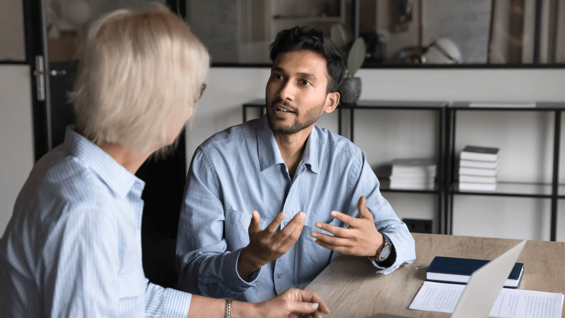 man explaining something to coworker