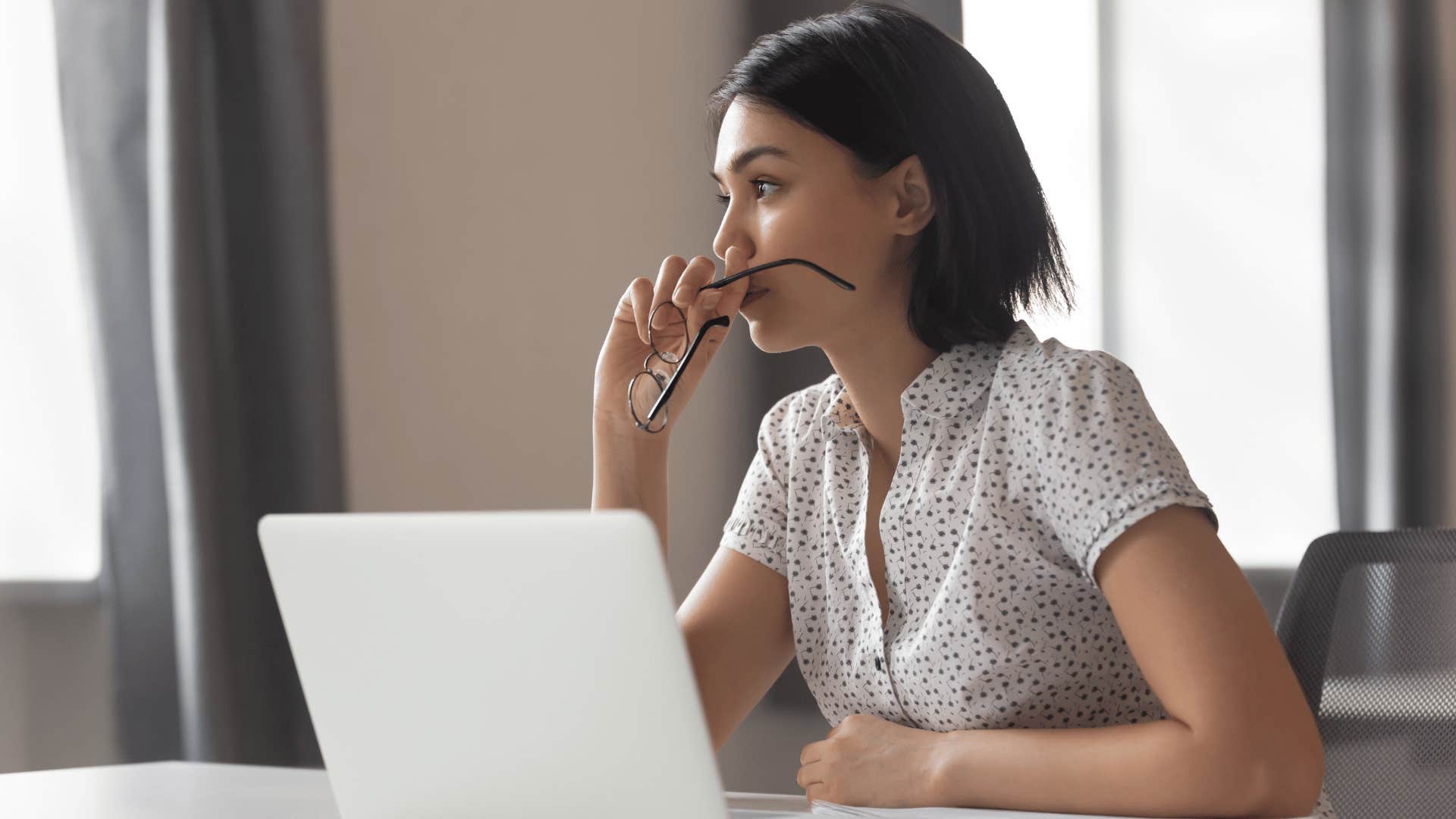 woman reflecting while working