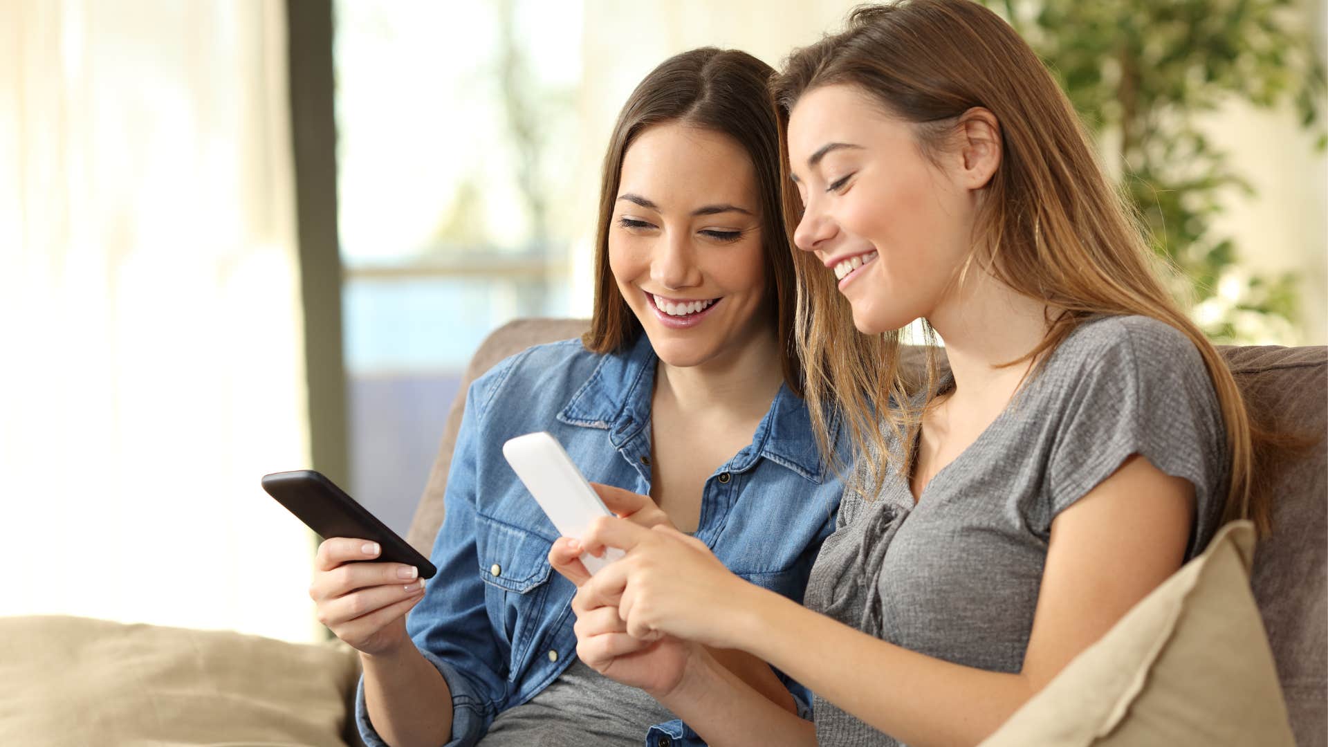 Two women exchanging their numbers with each other