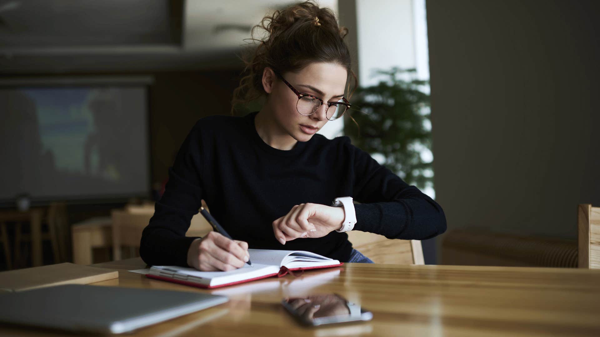 woman looking at watch