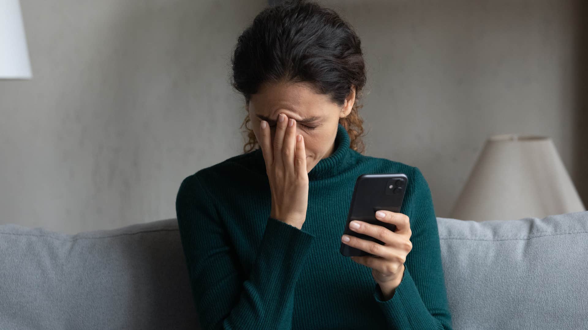 annoyed woman holding her phone