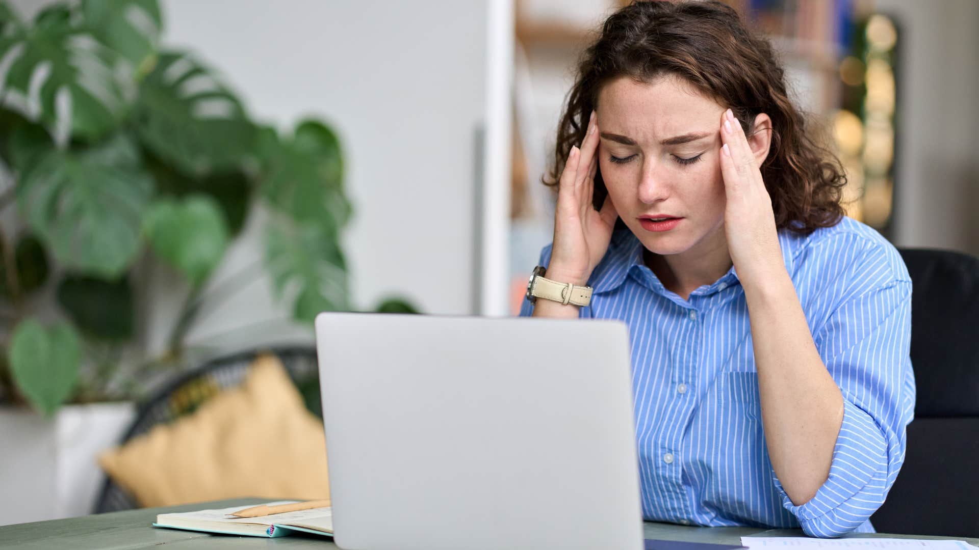 young woman holding her head in her hands