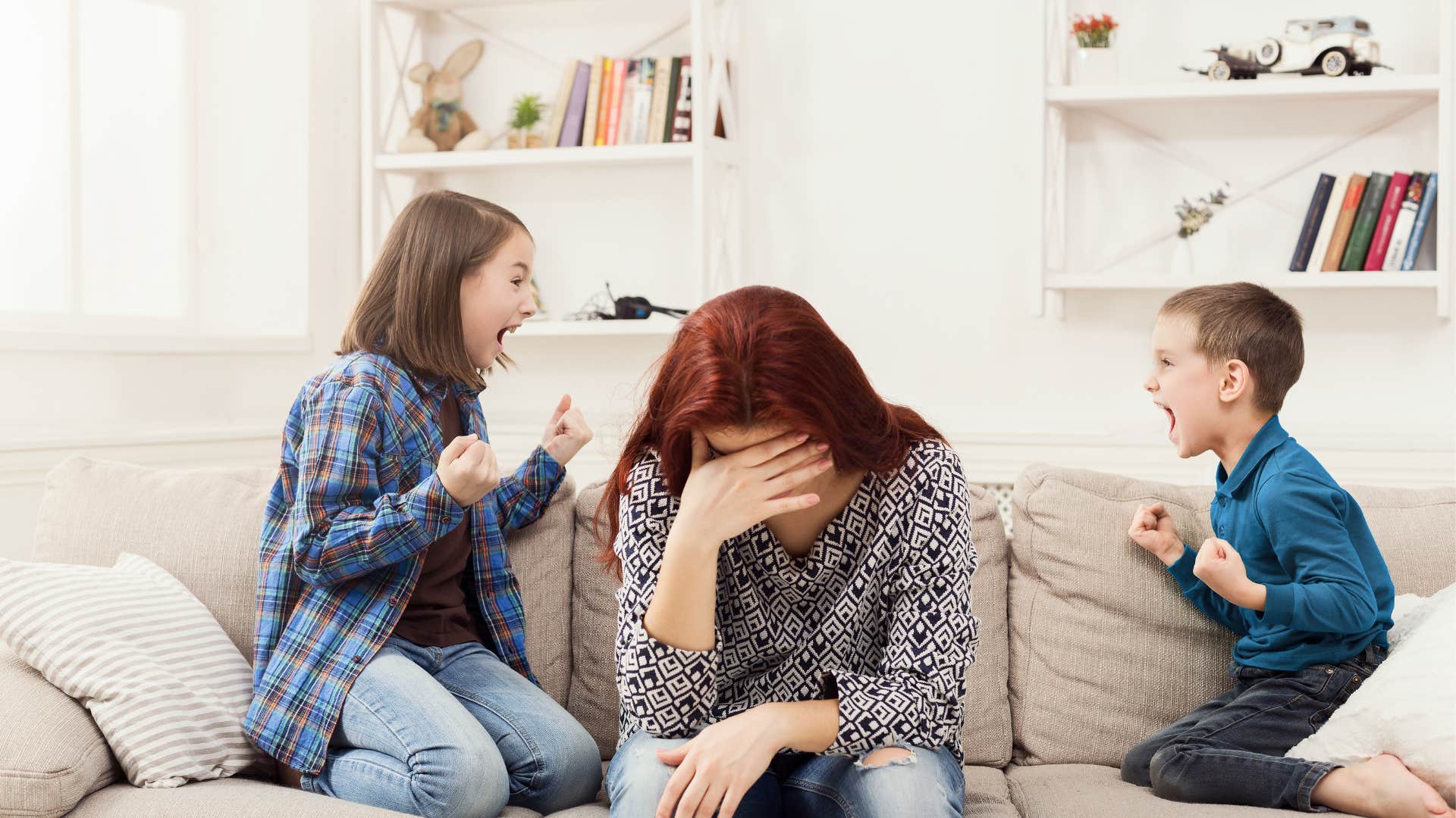 mother struggles with her two children getting them to quiet down