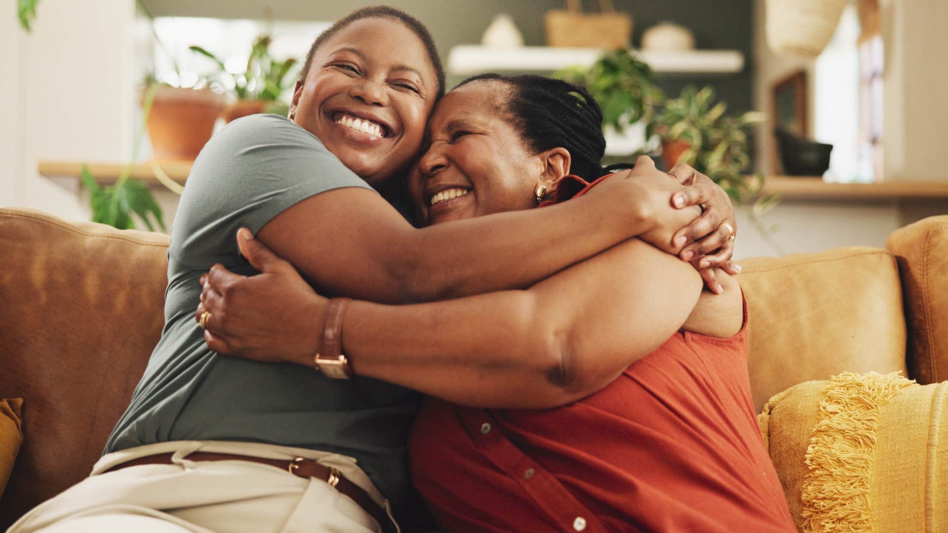 two women hugging each other happily