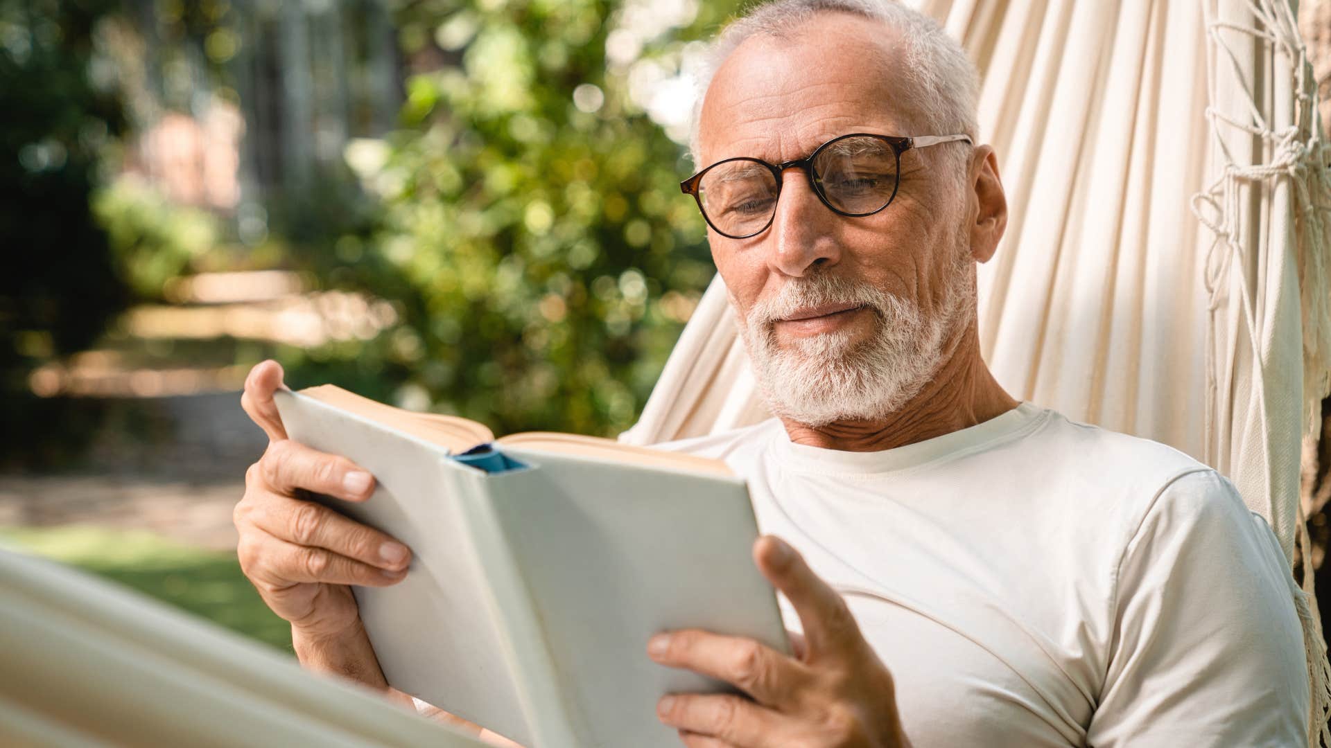 man practicing self-care reading a book