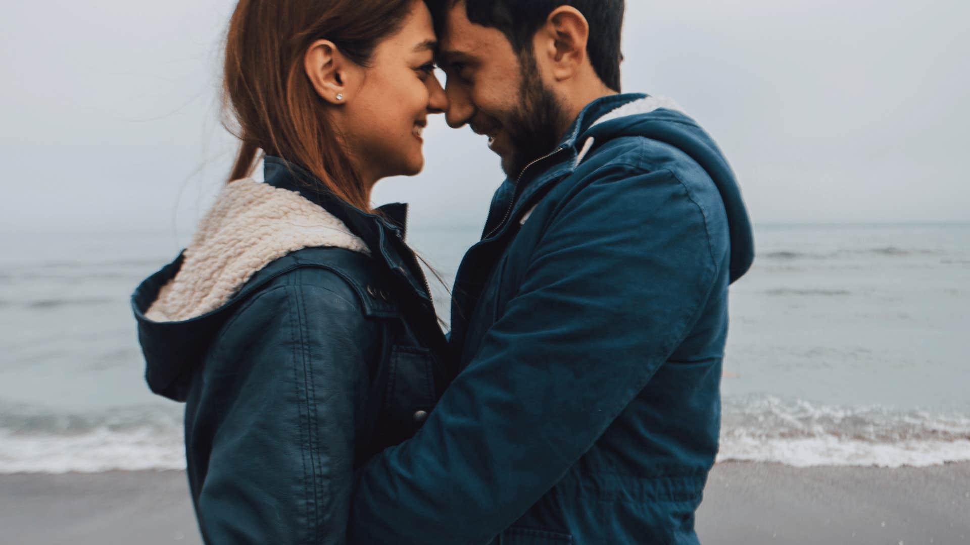 man and woman being vulnerable on the beach