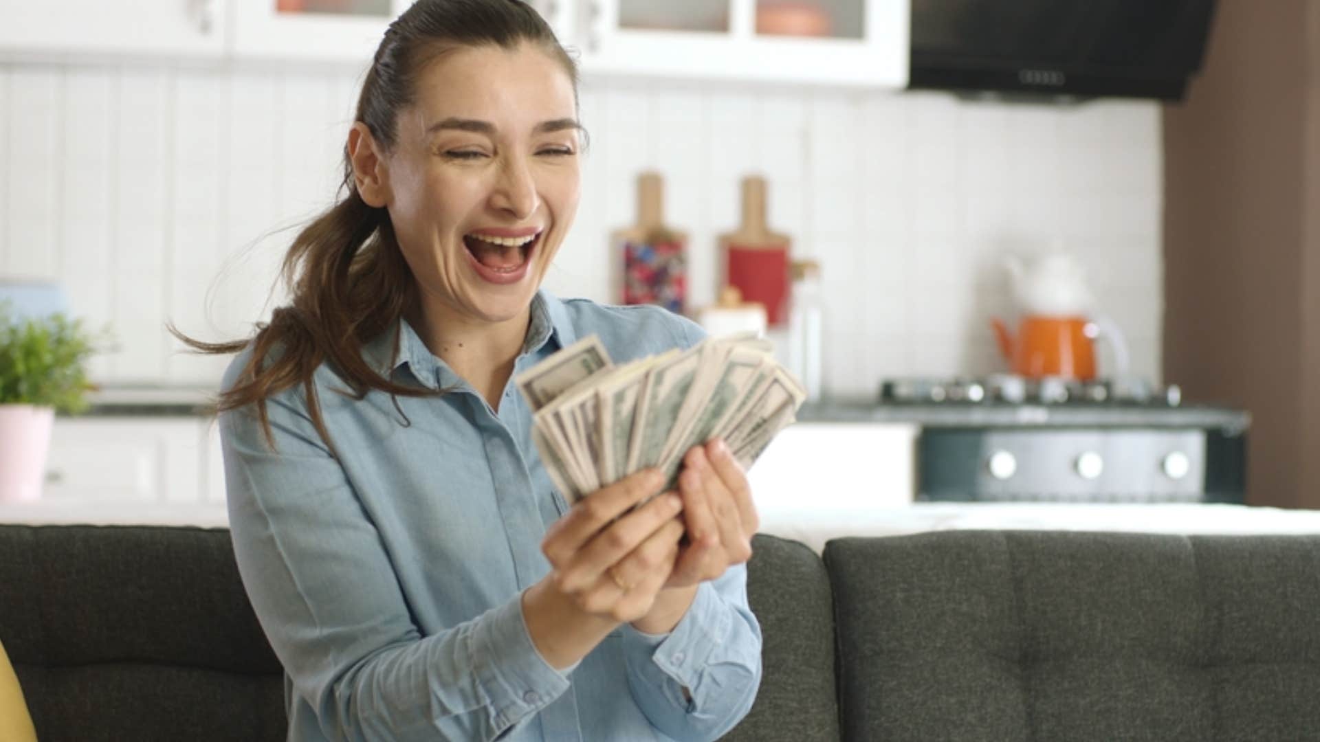 woman holding up money