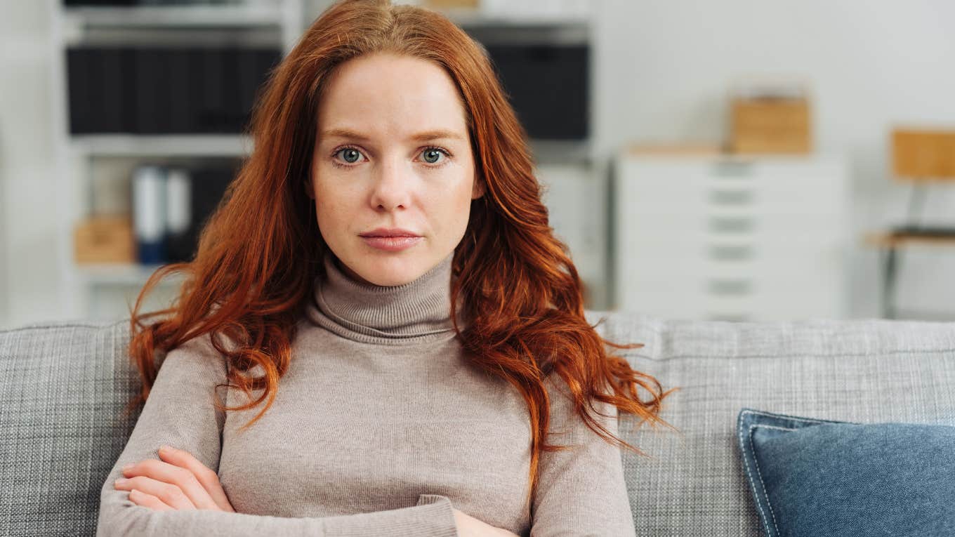 self-conscious redheaded woman staring intently