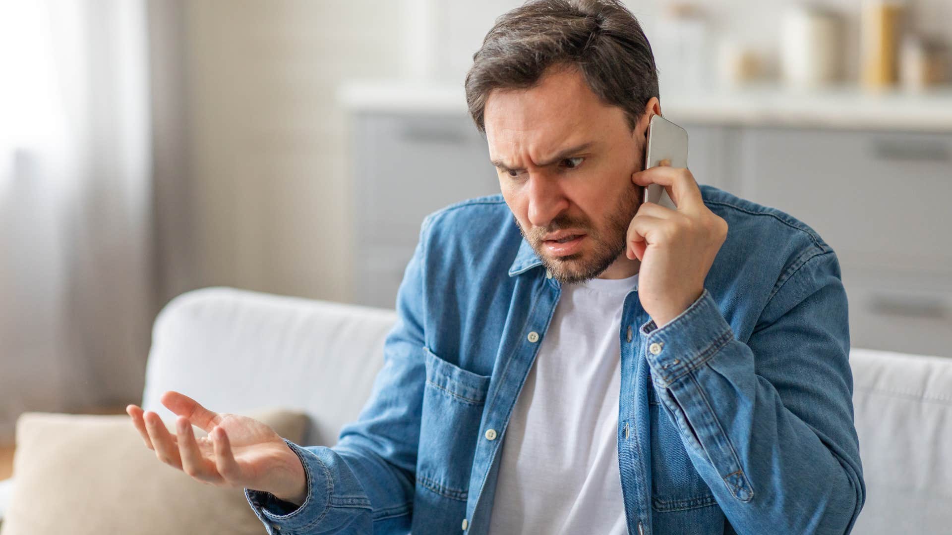 Upset man arguing with someone on the phone