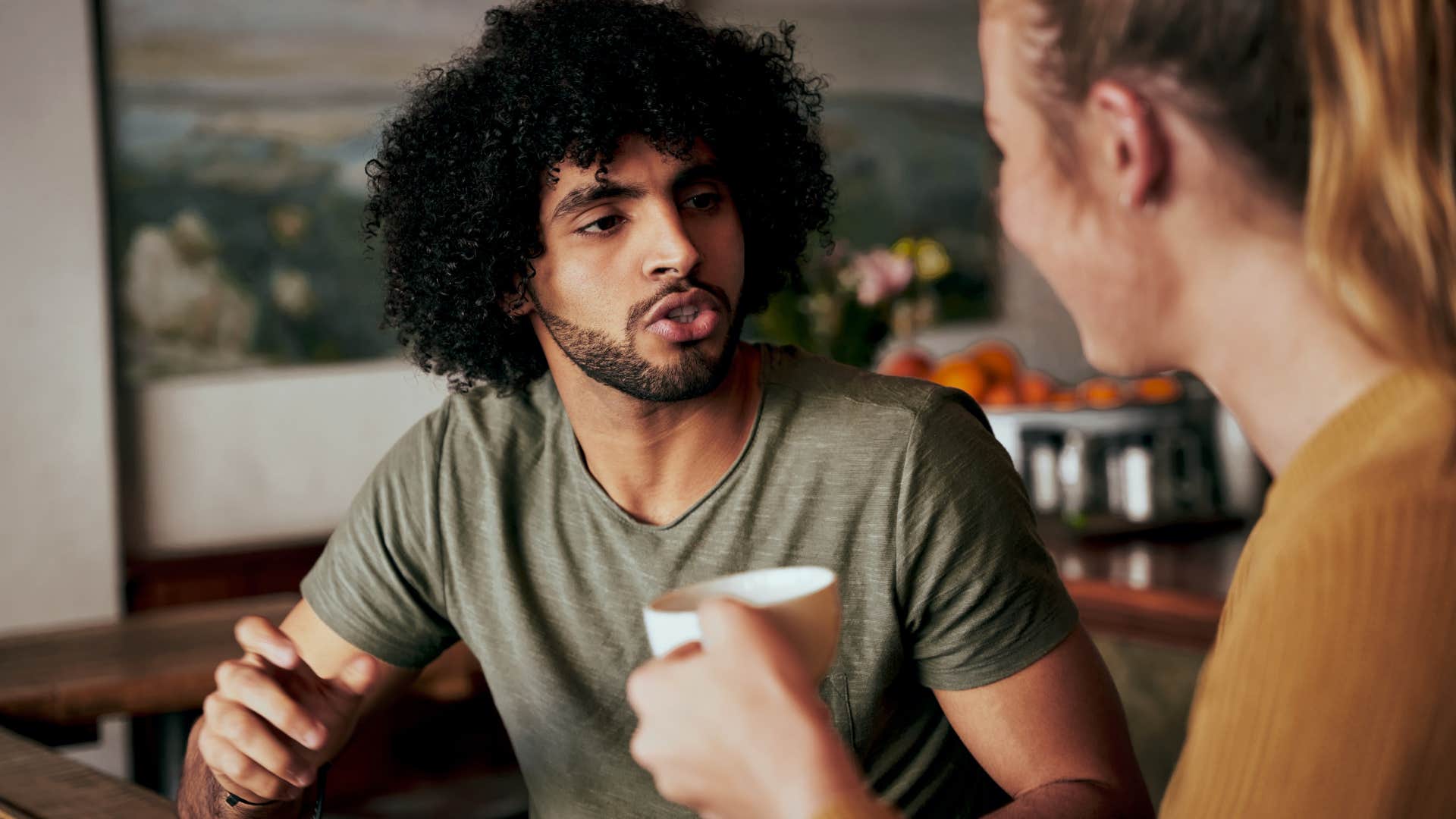 Man arguing with a woman in a coffee shop