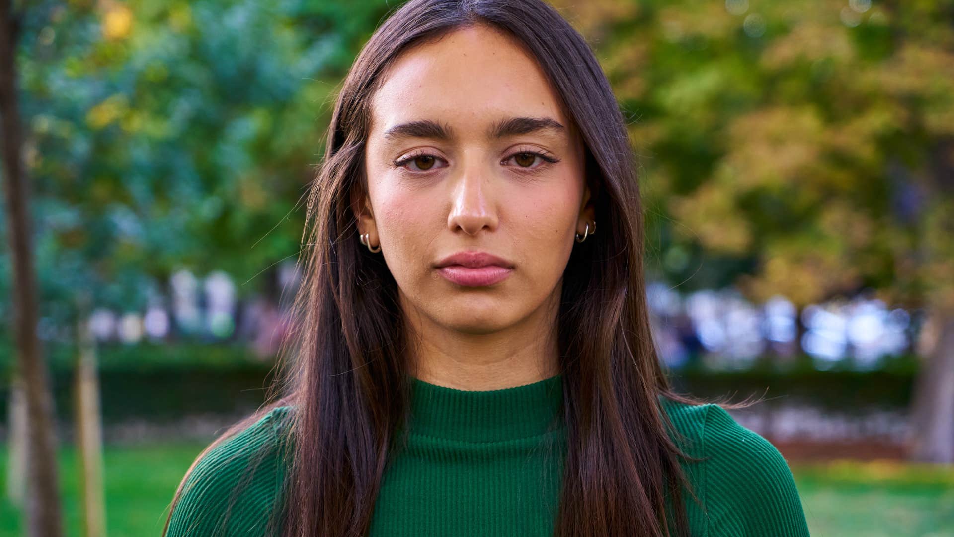 indifferent young woman standing outside