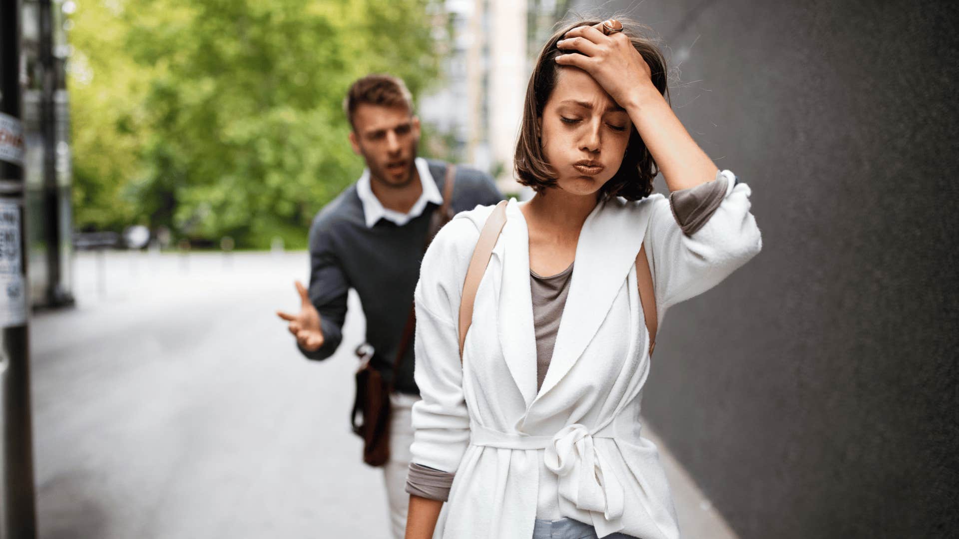 woman walking away from man after fight