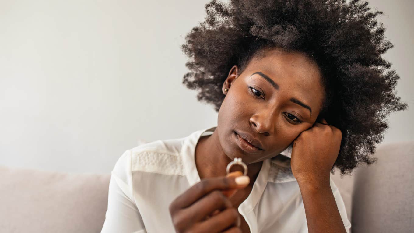 miserable wife looking at her wedding ring