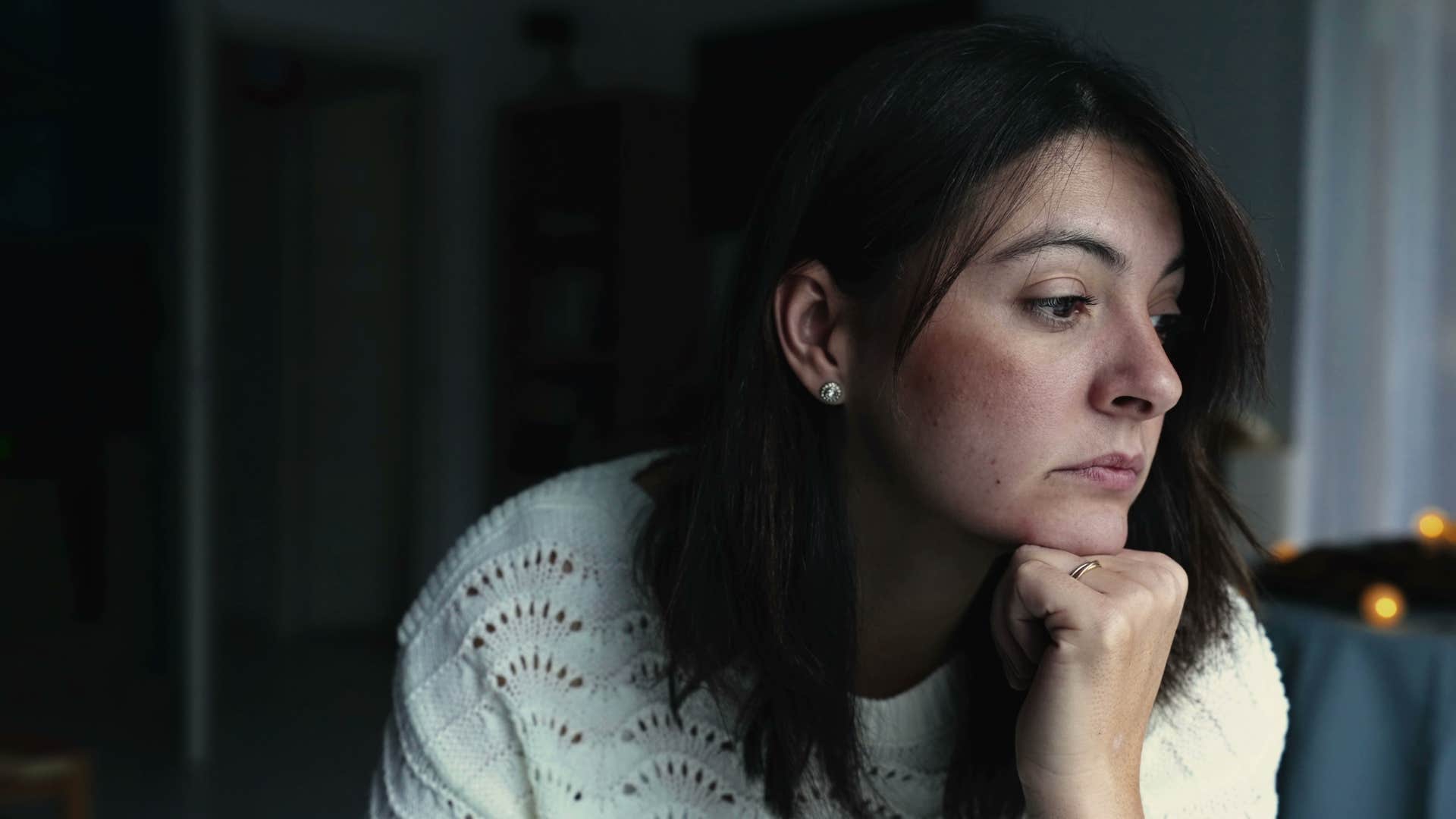 sad woman sitting in a dark room