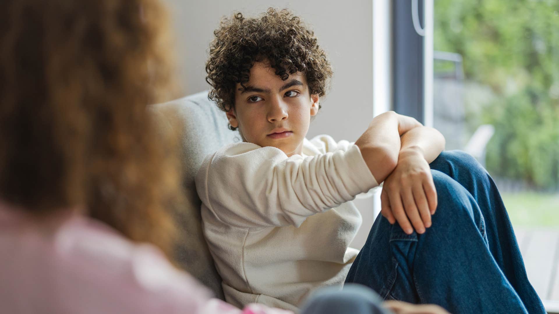 sad withdrawn boy talking to his mom