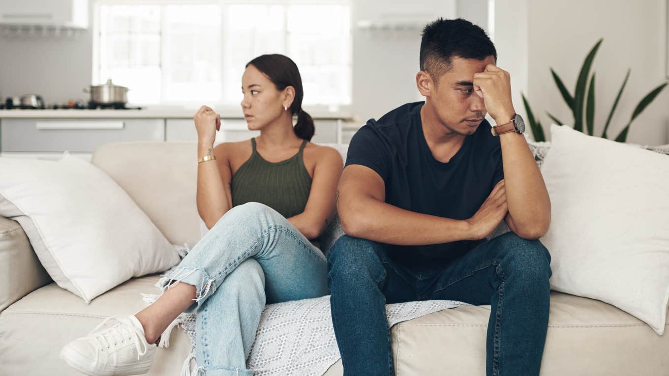 miserable married couple sitting side by side