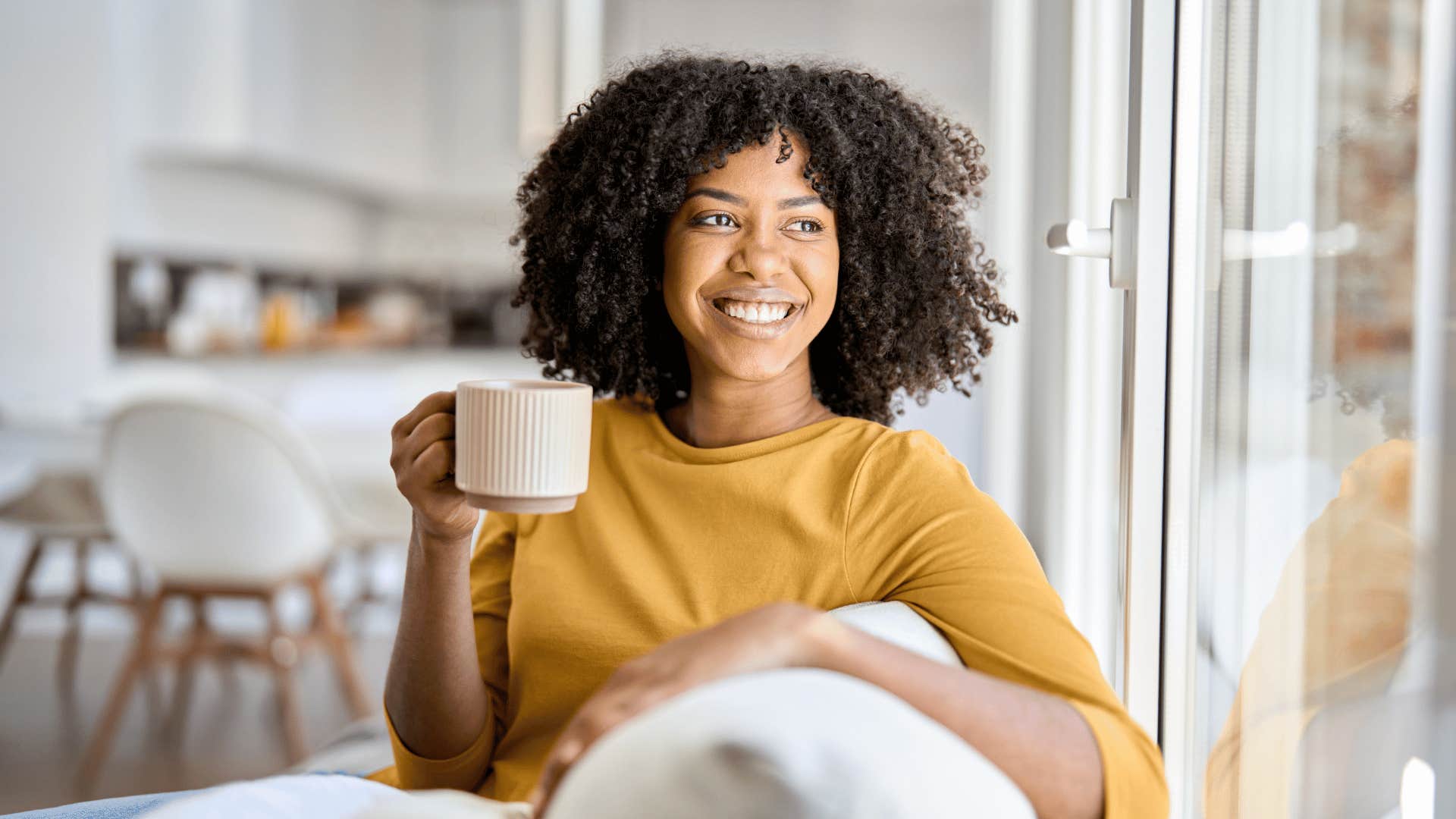 woman smiling and drinking coffee