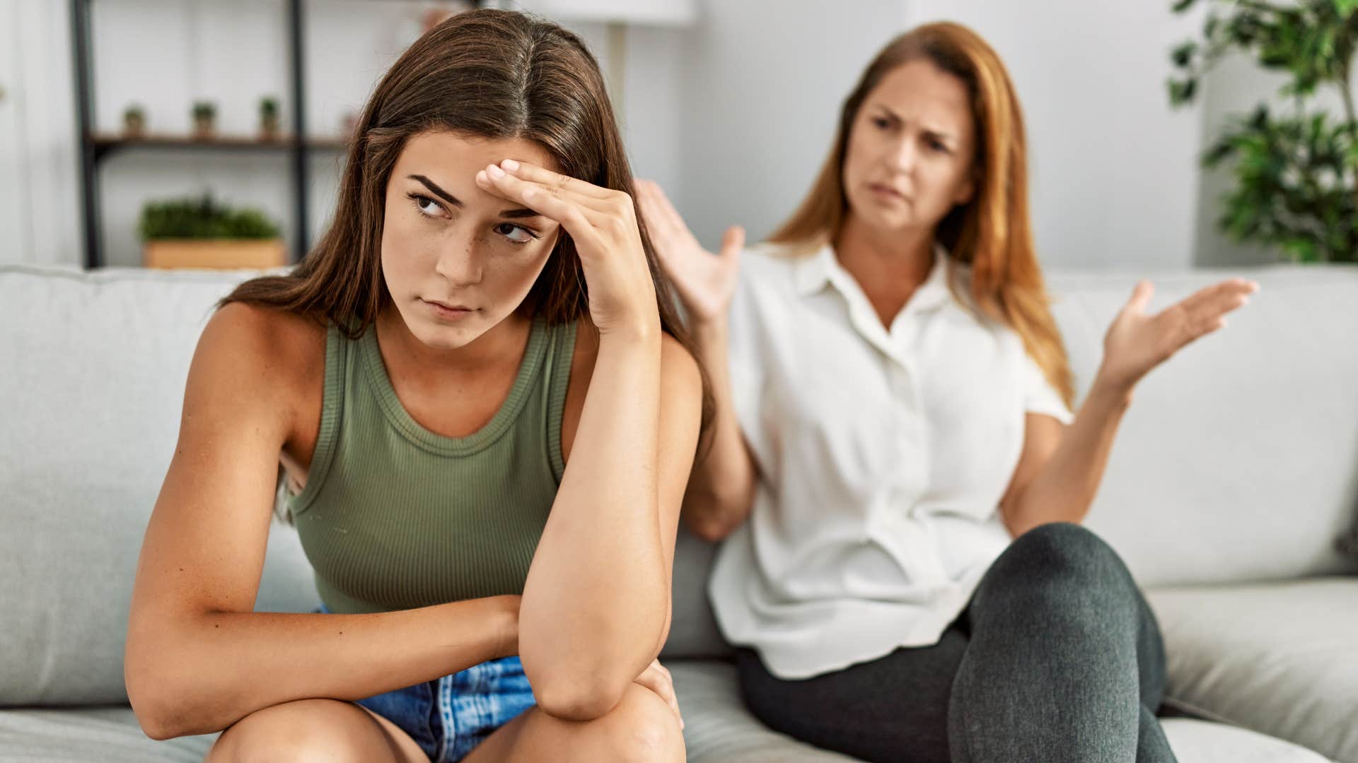 upset woman turned away from manipulative mother