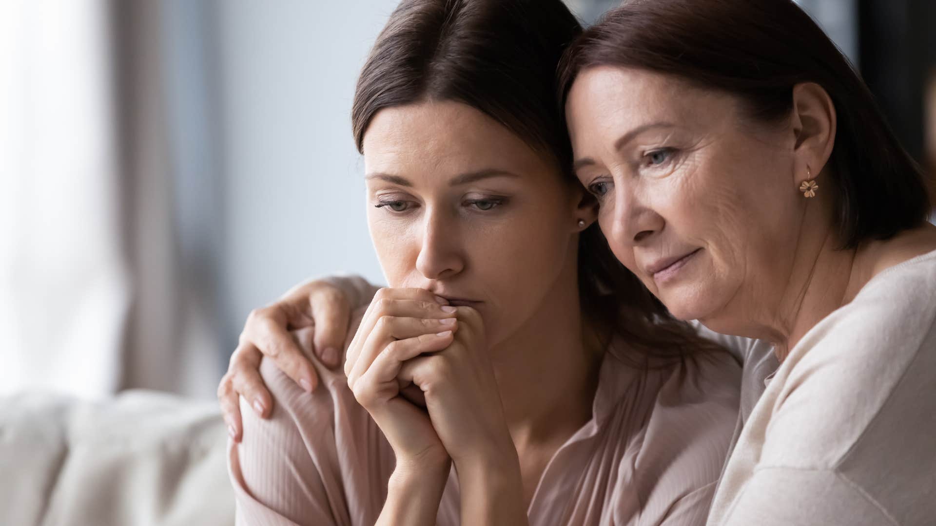 woman comforting her upset adult daughter