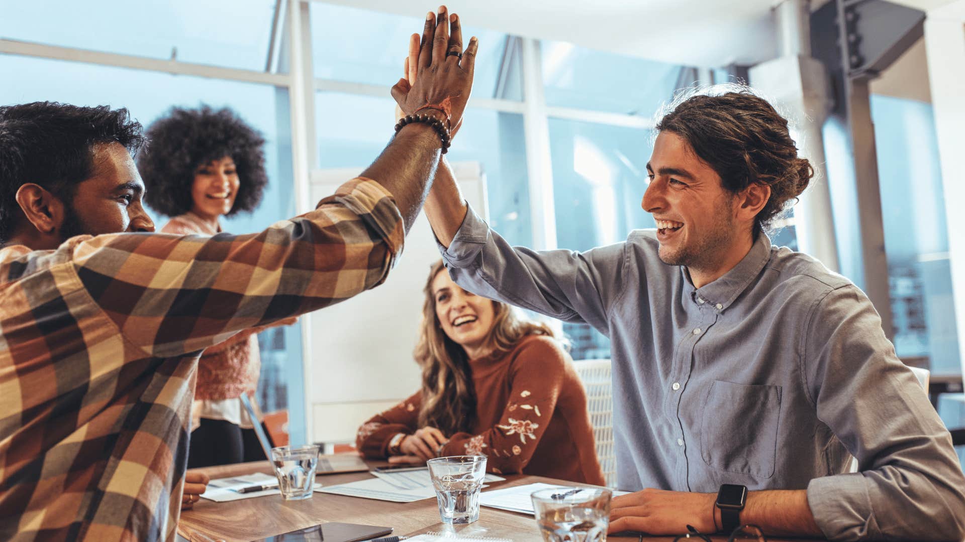 Gen Z team giving high fives