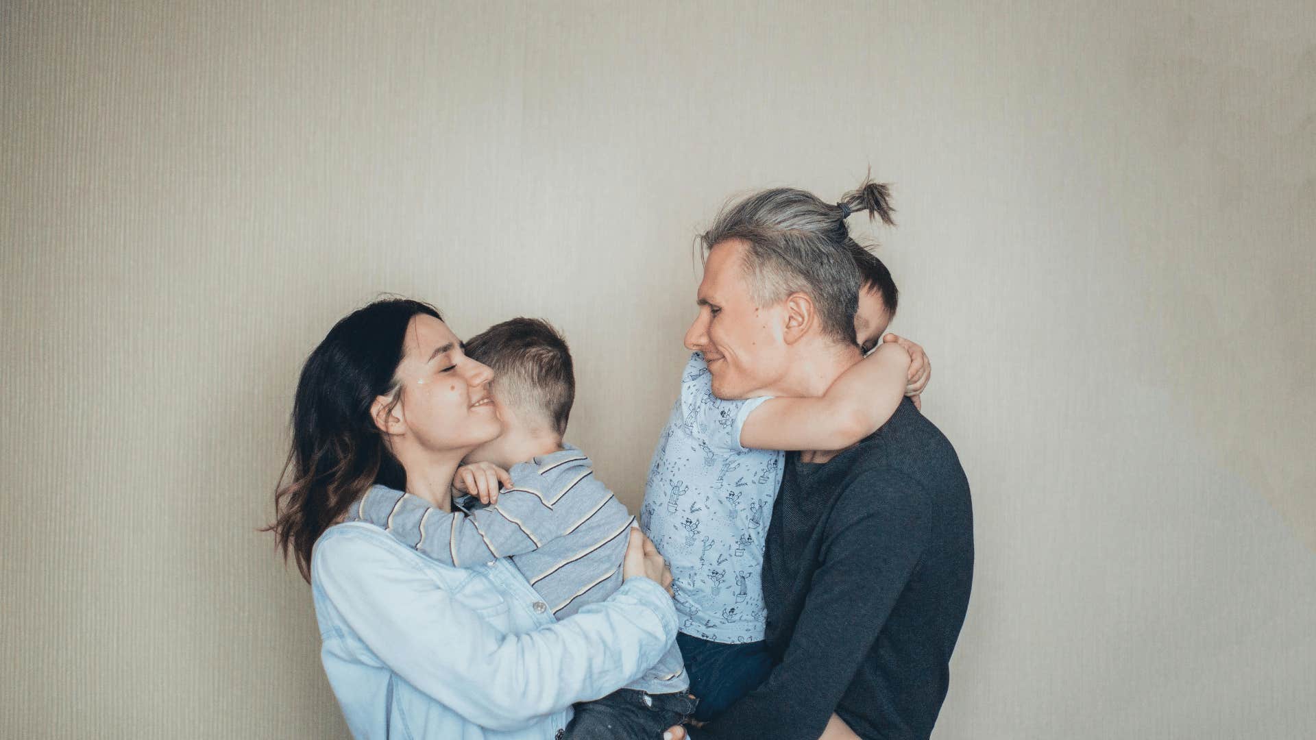 smiling parents holding children