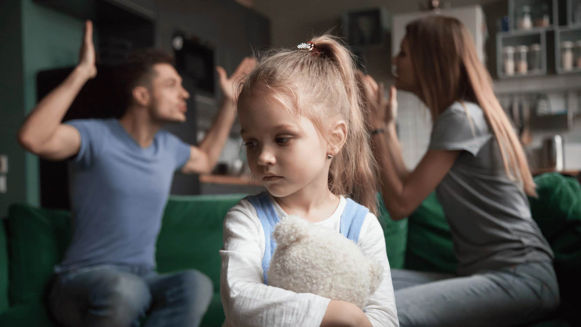 little girl stressed by arguing parents